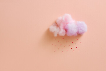 Cotton ball cloud rain sugar candy sprinkle hearts red pink on pink sky background