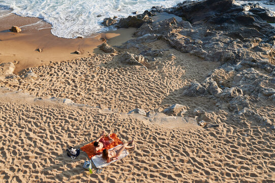 Couple Lying Together On A Sandy Beach