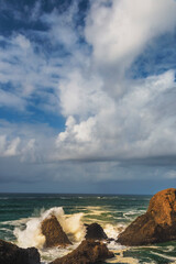 USA, Oregon, Newport. Waves breaking on rocks.