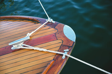 Vintage wooden boat with mooring ropes