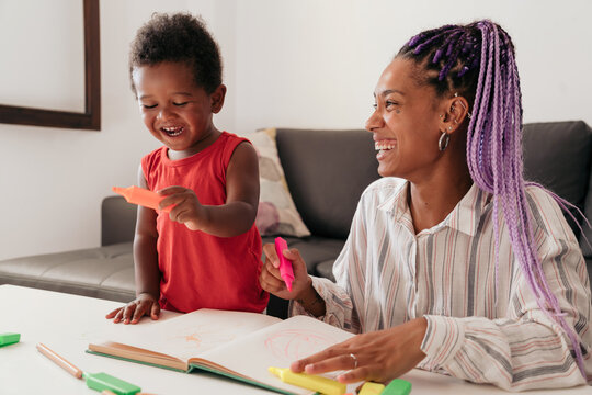 Mother and son drawing at home