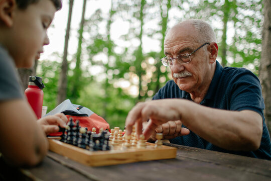 Grandfather playing chess with his grandson