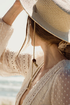 Trendy Young Woman Wearing A Hat Looking Into The Sun