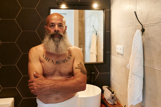Mature man standing in his bathroom