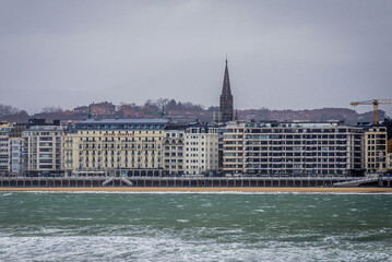 Fototapeta premium Coast in San Sebastian, view with cathedral tower, Spain
