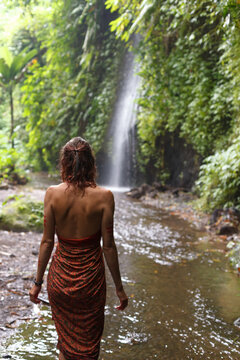 Girl Walks In Nature Near Waterfall