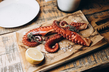 octopus and lemon platter on utensils
