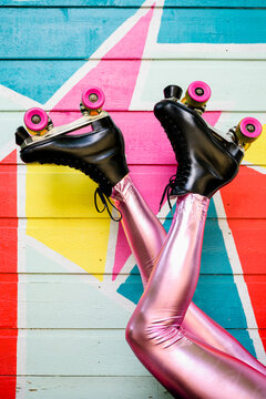 Feet with Roller Skates Kicking in front of Colorful Mural