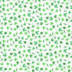 Seamless pattern with lime green and emerald green twigs, clover leaves on a white background. Watercolor hand drawn illustration may be used for wallpaper, textile and packaging paper