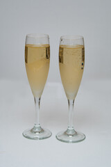 two glasses of champagne isolated on white
