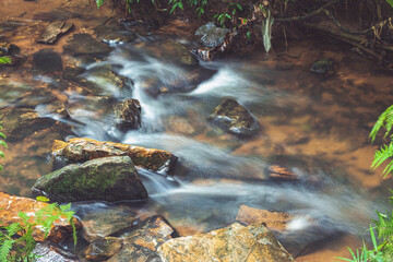 Crystal clear waterfall waters in long exposure
