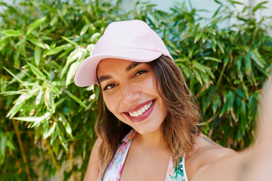 Smiling woman taking a selfie outside