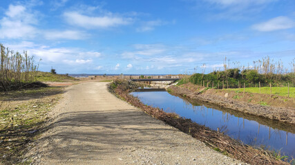 The Esposende Interceptor Canal. Canalized stream flowing through the agricultural area into the Atlantic Ocean at Marinhas in Esposende, Portugal.