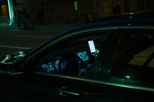 Checking the smartphone in the car, while not driving in a New York city Street.