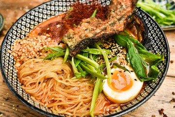 Miso Ramen Asian noodles with egg, pork and pak choi cabbage in bowl on white background. Japanese cuisine. Top view. Banner