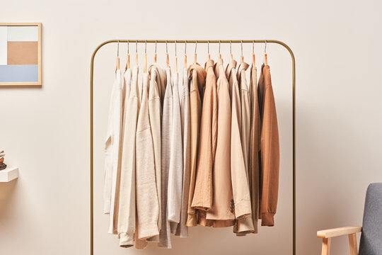 Rack with clothes in stylish room