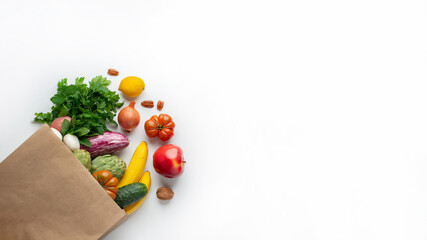 Fototapeta na wymiar Delivery healthy food background. Healthy vegan vegetarian food in paper bag vegetables and fruits on white, copy space, banner. Shopping food supermarket and clean vegan eating concept