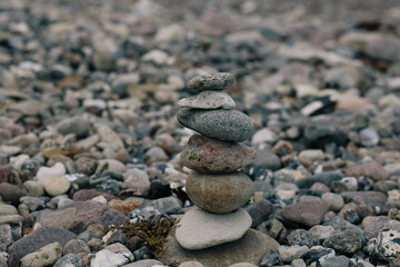 Fototapeta na wymiar Made of stone tower on the beach and blur background 
