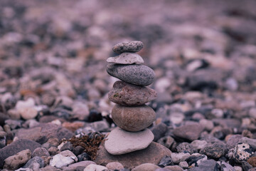 Fototapeta na wymiar Made of stone tower on the beach and blur background 