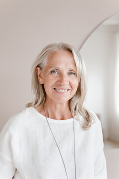 Happy middle aged woman looking at camera