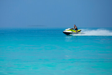 A man on a jetski in the Maldives