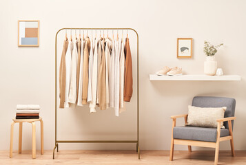 Armchair and shelf near clothes rail