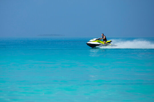 A man on a jetski in the Maldives