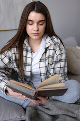 student female reading paper book