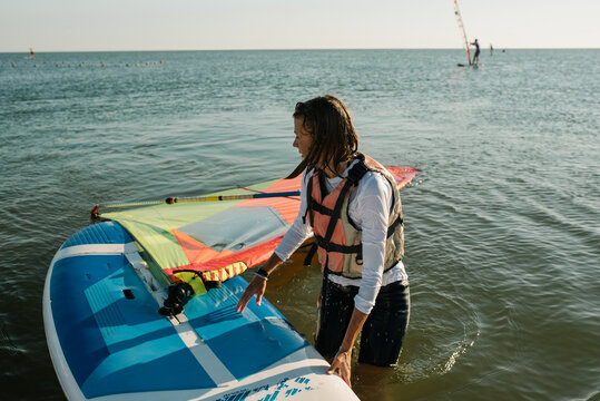A girl sails on a windsurf on the sea