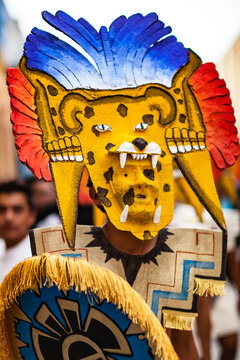 A Man Wearing an Elaborate Yellow Paper Mache Masks