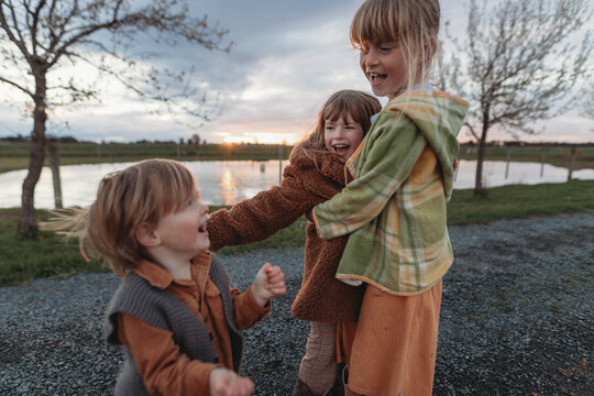 Three Young Kids Cuddling