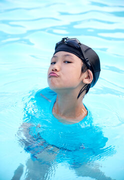 Cute Asian girl playing with water in hot spring swimming pool