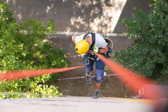 Working at elevations. Rope access, high-altitude outdoor work.