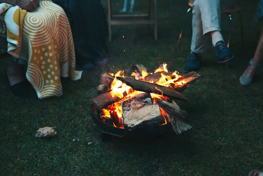 sitting around the bonfire by dusk