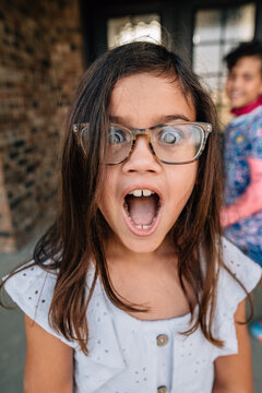 Young girl with silly facial expression.