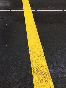 yellow and white lines on asphalt road