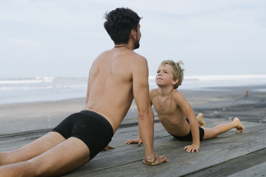Father With Son Doing Yoga - Powered by Adobe