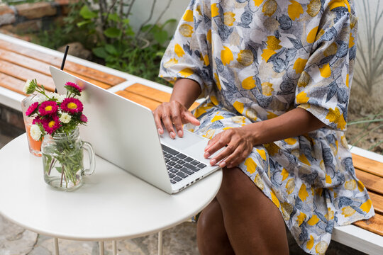 Anonymous Black Woman Working On Laptop Outdoors