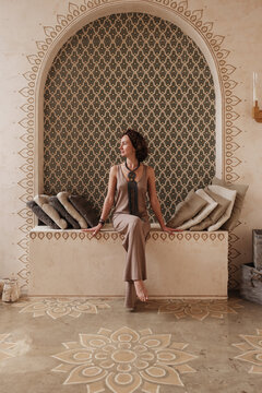 Elegant woman resting in oriental room