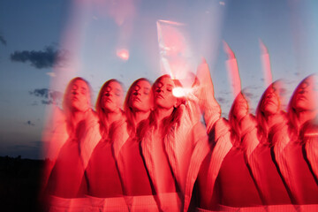 Kaleidoscop. Colorful fashion portrait of trendy woman in minimalist clothes posing outdors under neon light
