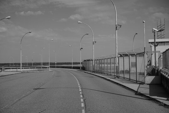 Deserted road next to an abandoned power station - Powered by Adobe