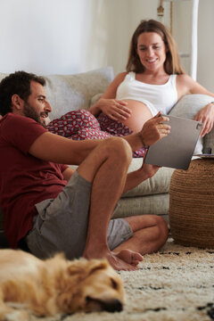 Optimistic couple using tablet together