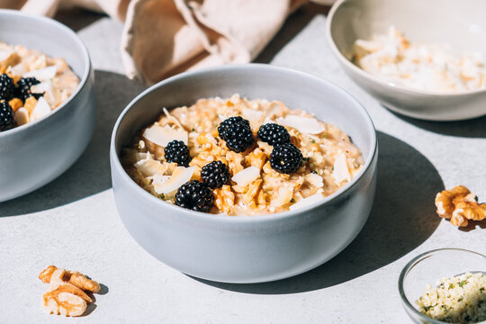Homemade porridge topped with wild blackberries, walnuts and shr
