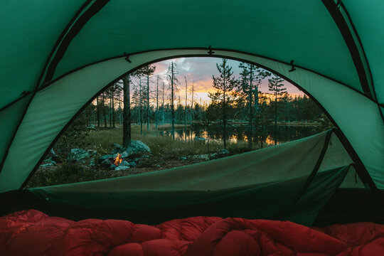 Nordic Sunset At Tent Campsite With Campfire by Lake