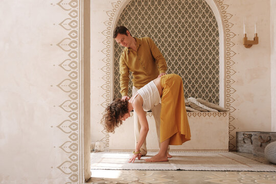 Man helping woman to do Halfway Lift