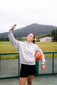 Sport Girl Taking A Selfie On The Basketball Court.