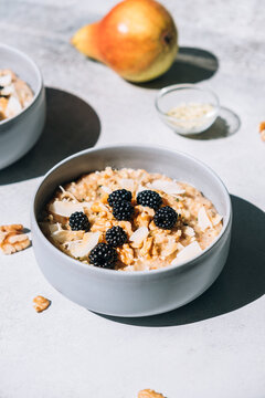 Homemade porridge topped with wild blackberries, walnuts and shr