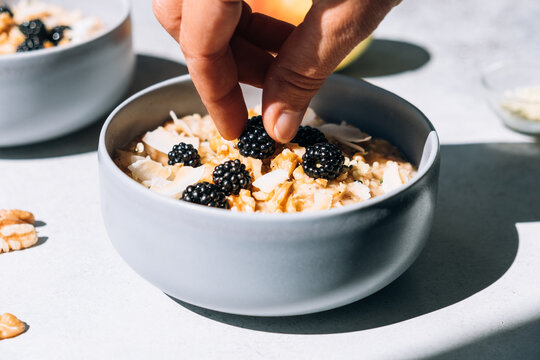 Homemade porridge topped with wild blackberries, walnuts and shr