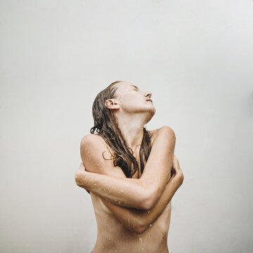 Young naked woman in the rain