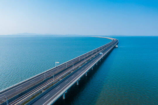 Fototapeta Aerial view of bridge road with cars over lake or sea